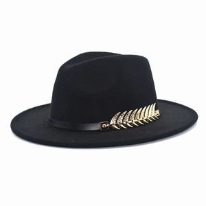 Detail of black wool fedora hat with elegant gold leaf metal accent and leather band