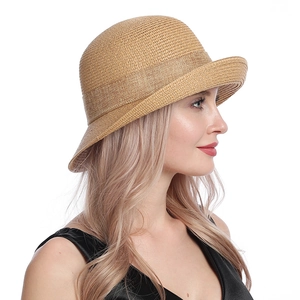 Close-up of khaki straw hat with elegant bow and fine woven texture for summer shade