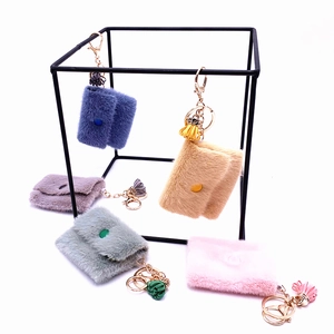 Mini plush candy-colored coin purse keychains with gold clasps and tassel charms