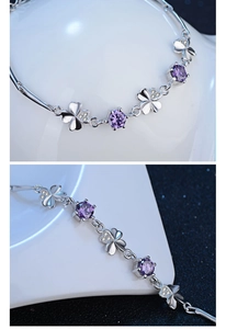Macro detail of S925 silver clover bracelet with purple zircon and sparkling stones