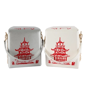 Macro shot of silver and white takeout box crossbody bags with chain straps
