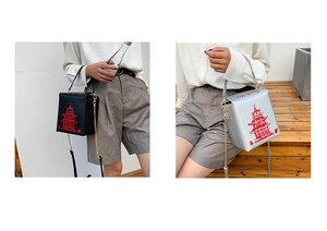 Creative takeout box cross-body bag with red tower print and gold chain strap details