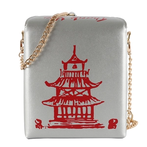 Detail of silver takeout box bag with red pagoda print and golden chain strap