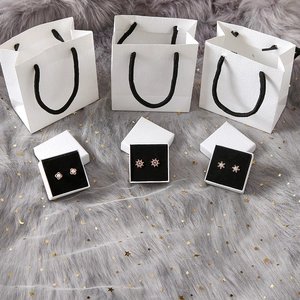 Three-piece rose gold earring set featuring heart and pearl motifs with elegant gift boxes