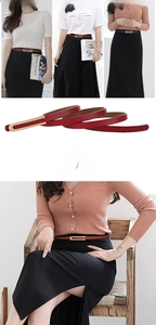 Détail d'une fine ceinture en cuir pour femme avec boucle dorée en forme de U élégante