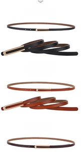 Détail de fines ceintures en cuir véritable avec boucles en U dorées en noir et camel