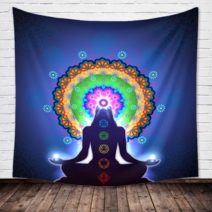 Bohemian Seven Chakra Mandala tapestry with meditation silhouette on a brick wall