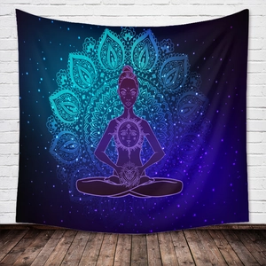 Detail of bohemian mandala tapestry featuring meditation silhouette on white brick wall