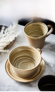 Close-up of handmade stoneware coffee cup with spiral kiln glaze and retro sesame dots