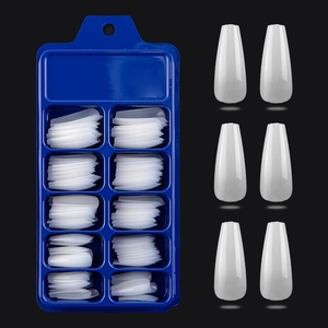 Detail of white translucent long coffin press on nails in a blue 10-slot storage box