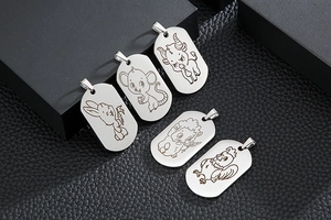 Detail view of five stainless steel military dog tags featuring zodiac animal engravings