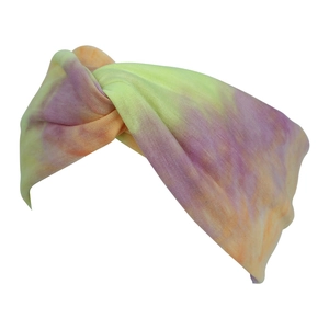 Detail of bohemian tie-dye knotted headband showing soft yellow and purple knit texture