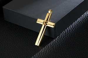 Macro shot of gold-plated stainless steel double-layered cross pendant with rivet detail