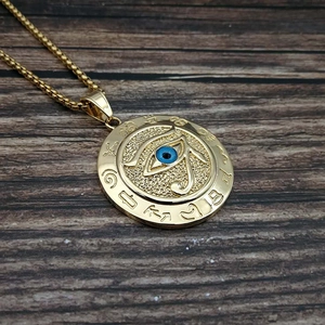 Golden Egyptian Eye of Horus necklace with blue eye detail on circular pendant