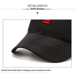 Detail of sturdy baseball cap brim with red embroidery and textured diamond fabric