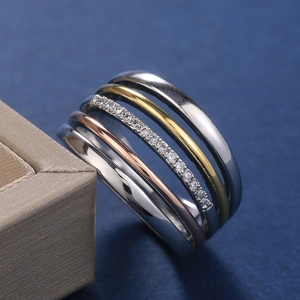 Three-tone stackable rings in silver, gold, and rose gold with zircon stones