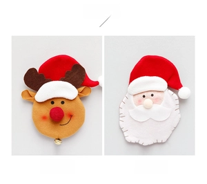 Detail of felt Christmas cutlery holders featuring reindeer and Santa Claus embroidery