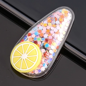 Close-up of glitter filled BB hair clip with a yellow lemon slice silicone charm