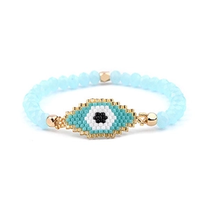 Detailed view of handmade Miyuki bead evil eye bracelet with blue and gold faceted beads