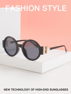 Close-up of golden metal hollow hinge on black retro round sunglasses frame