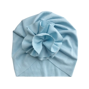 Detail of light blue ribbed cotton baby turban hat with a large floral fold decoration