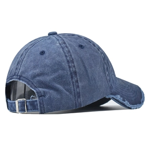 Detail view of the vintage washed denim baseball cap featuring a metal adjustable buckle