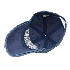 Detail of 100% cotton inner label and frayed edge of navy vintage baseball cap