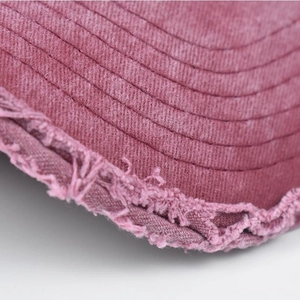 Detail of vintage washed rose pink cotton baseball cap with raw edges and reinforced stitching
