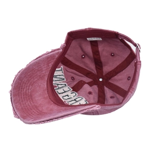 Detail of burgundy washed cotton baseball cap with adjustable strap and inner lining