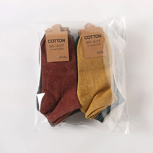 Macro detail of men's cotton wool mix socks in burgundy and yellow with speckled texture