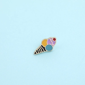 Close-up of a colorful enamel ice cream cone brooch with vibrant gold finish detail