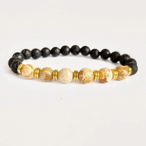 Volcano rock and tiger eye stone bead bracelet with golden metal spacers on white background