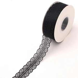 Detailed view of 25 yards of black lace ribbon roll with delicate floral mesh pattern