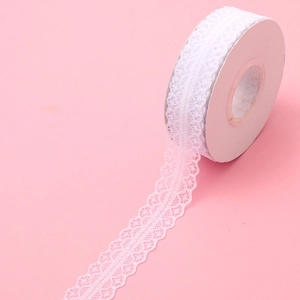 Detailed view of white scalloped lace ribbon roll for flower bouquet and gift wrapping
