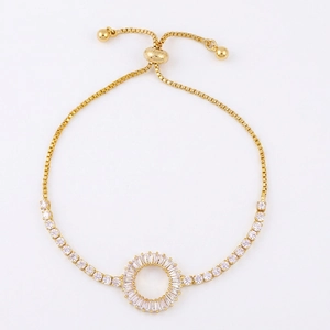 Macro shot of gold-plated bracelet with circular pave-set zirconia and box chain detail