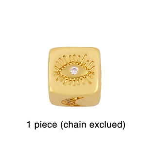 Detail of bohemian gold-plated cube bead with evil eye relief and clear zircon stone