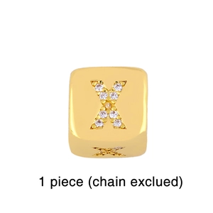 Detail of gold cube charm with crystal rhinestone letter X inlay for DIY bracelets