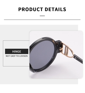 Detail of round sunglasses featuring a golden CD-shaped metal hinge for a luxury look