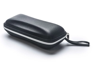 Detail of black litchi grain leather sunglass case with silver zipper and handle strap