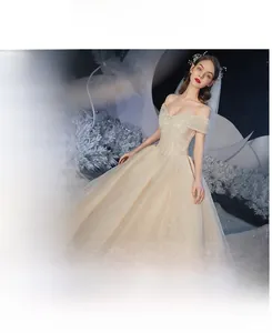 Champagne bridal gown detail featuring sparkling sequins and elegant off-shoulder neckline