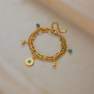 Double-layered gold stainless steel bracelet with turquoise stone and sunburst round charm