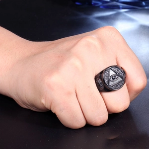 Close-up of matte black punk-style stainless steel ring featuring the eye of providence