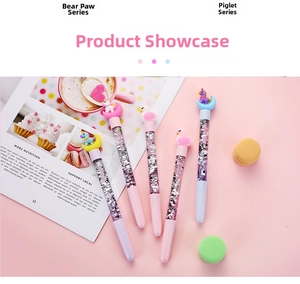 Detailed view of creative cartoon quicksand pens with unicorn and swan toppers on desk