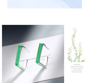 Detail view of minimalist square silver earrings with glossy green enamel finish