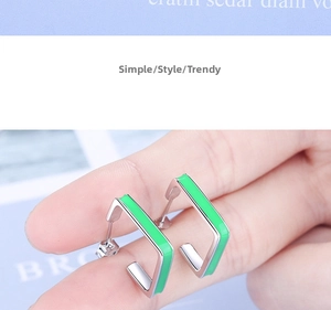 Detailed macro view showing S925 sterling silver stamp on small green square earrings