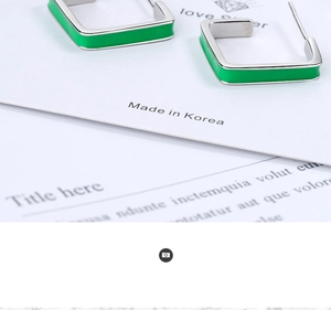 Macro shot of square geometric enamel earrings in bright green and silver finish