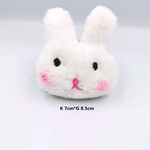 Detail showing plush white rabbit brooch with pink cheeks and 7x8.5cm size scale