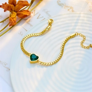 Golden Cuban chain bracelet with a green heart gemstone and adjustable lobster clasp