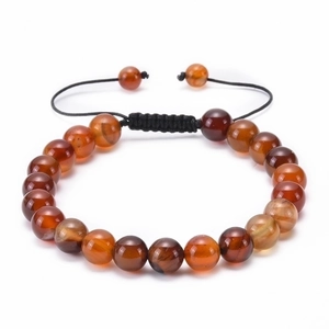 Close-up of brown carnelian beads with an adjustable black woven sliding knot cord