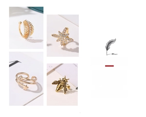 Macro detail of gold-plated leaf and star ear cuffs with bohemian cubic zirconia accents